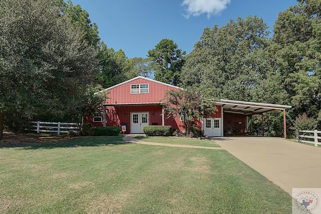 view of front of property with a front lawn, an outdoor structure, and a carport