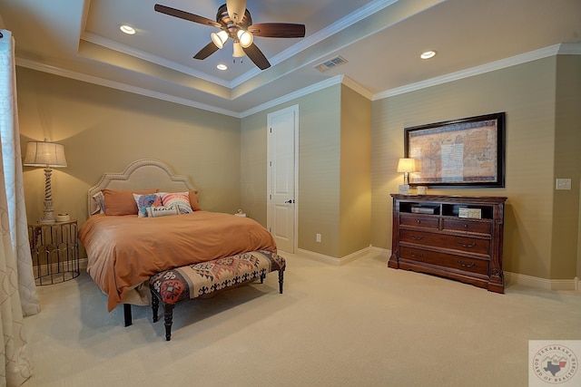 carpeted bedroom featuring ceiling fan, crown molding, and a tray ceiling