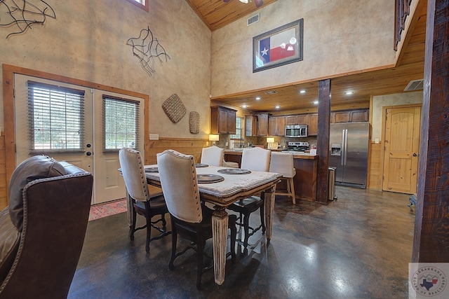 dining area with high vaulted ceiling, wooden ceiling, and french doors