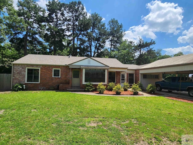 ranch-style house featuring a front lawn and a carport