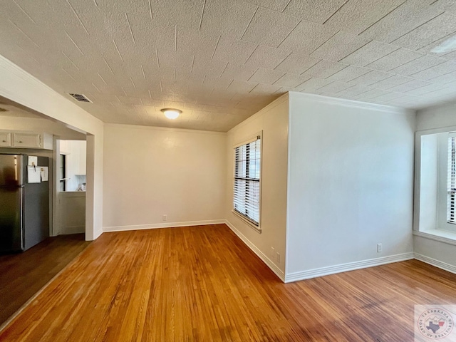 empty room with hardwood / wood-style flooring