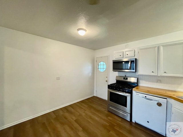 kitchen featuring a textured ceiling, white cabinets, appliances with stainless steel finishes, dark hardwood / wood-style flooring, and butcher block countertops