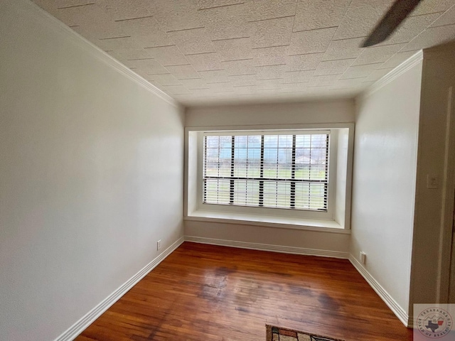 unfurnished room featuring hardwood / wood-style flooring and crown molding