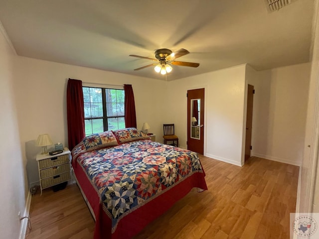 bedroom with ceiling fan and light hardwood / wood-style flooring