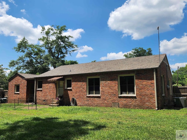 single story home with central AC and a front lawn