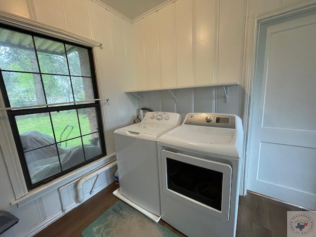 laundry room with dark hardwood / wood-style floors and washer and dryer