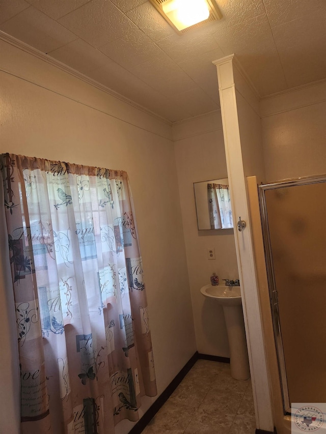 bathroom featuring a shower and crown molding