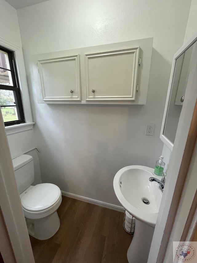 bathroom featuring sink, hardwood / wood-style floors, and toilet