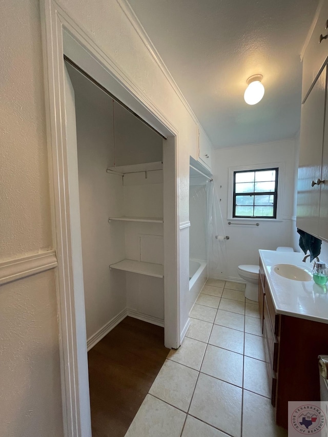 full bathroom featuring vanity, toilet, bathing tub / shower combination, and tile patterned flooring