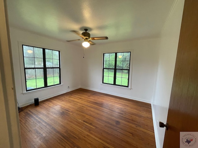 spare room with dark wood-type flooring and ceiling fan