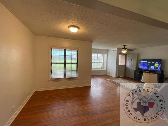 unfurnished living room featuring hardwood / wood-style flooring and ceiling fan