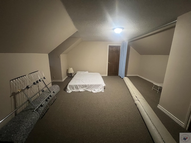 bedroom featuring dark colored carpet, a textured ceiling, and vaulted ceiling