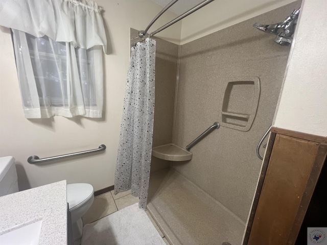 bathroom featuring vanity, toilet, a shower with shower curtain, and tile patterned flooring