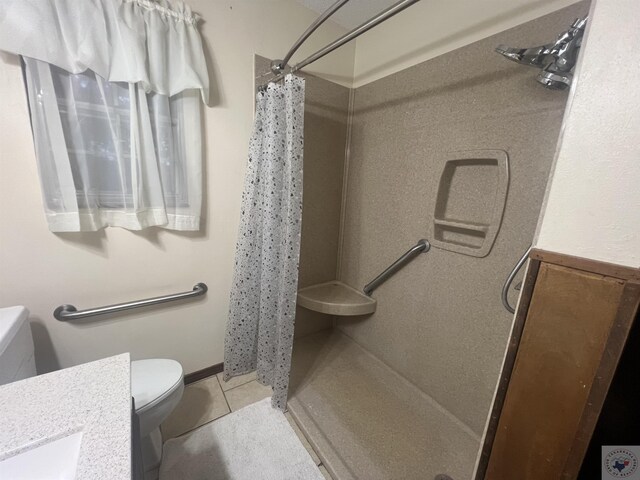 bathroom featuring vanity, toilet, a shower with shower curtain, and tile patterned flooring