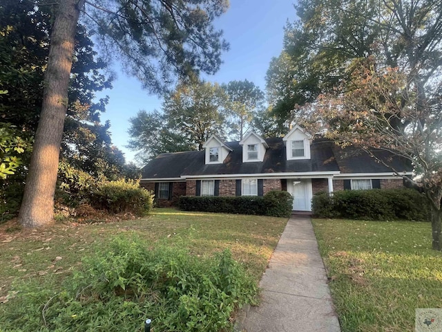 new england style home featuring a front yard