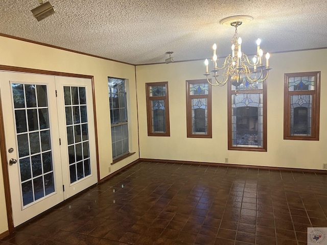 unfurnished room with a chandelier and a textured ceiling