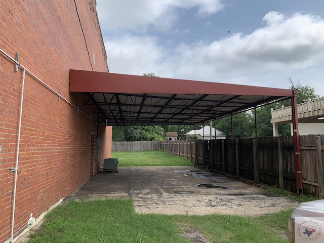 view of parking / parking lot featuring a yard