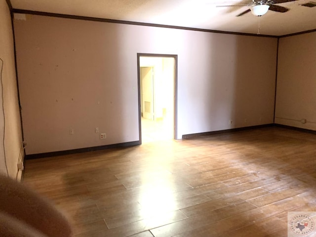 spare room featuring crown molding, hardwood / wood-style flooring, and ceiling fan