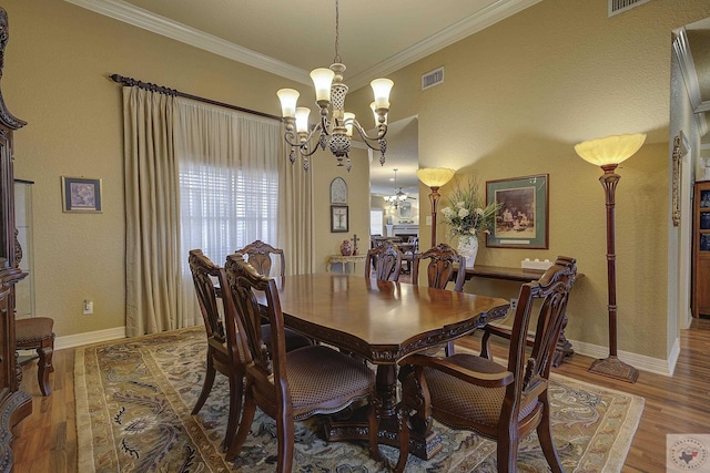 dining room featuring wood-type flooring, crown molding, and a chandelier