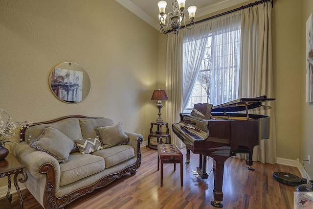 living area featuring a notable chandelier, hardwood / wood-style flooring, and ornamental molding