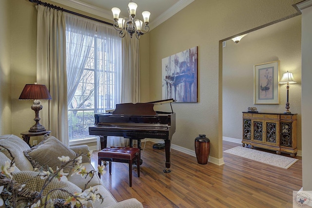 living area with hardwood / wood-style floors, crown molding, and a notable chandelier