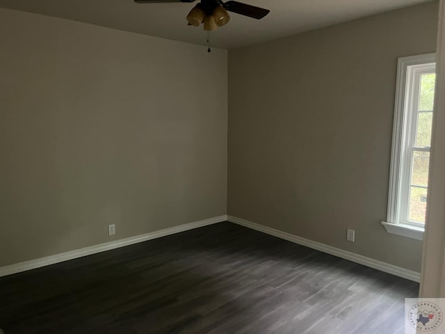 spare room with plenty of natural light, dark hardwood / wood-style floors, and ceiling fan