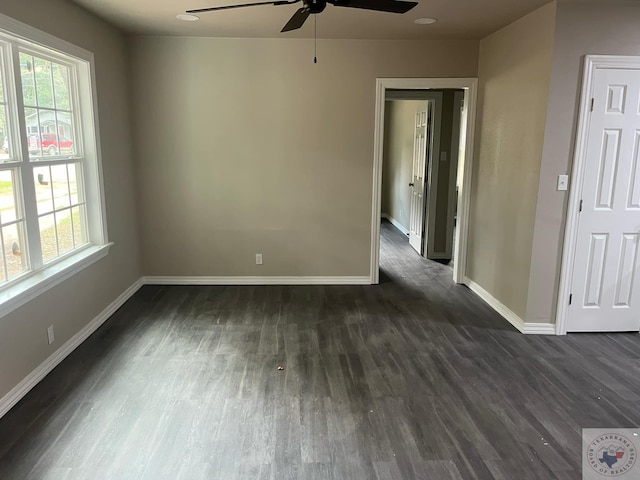 empty room featuring ceiling fan and dark hardwood / wood-style floors