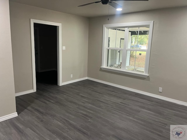 unfurnished room with ceiling fan and dark wood-type flooring