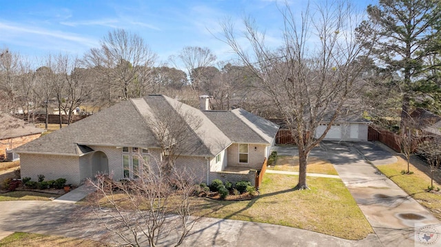 view of front of house with brick siding, a chimney, a shingled roof, a garage, and a front lawn