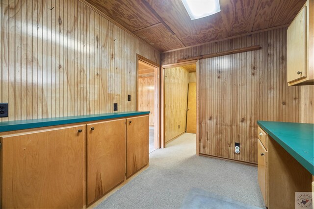 bar with wood ceiling, light carpet, and wooden walls