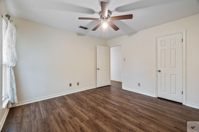 unfurnished bedroom with dark wood-type flooring, visible vents, ceiling fan, and baseboards