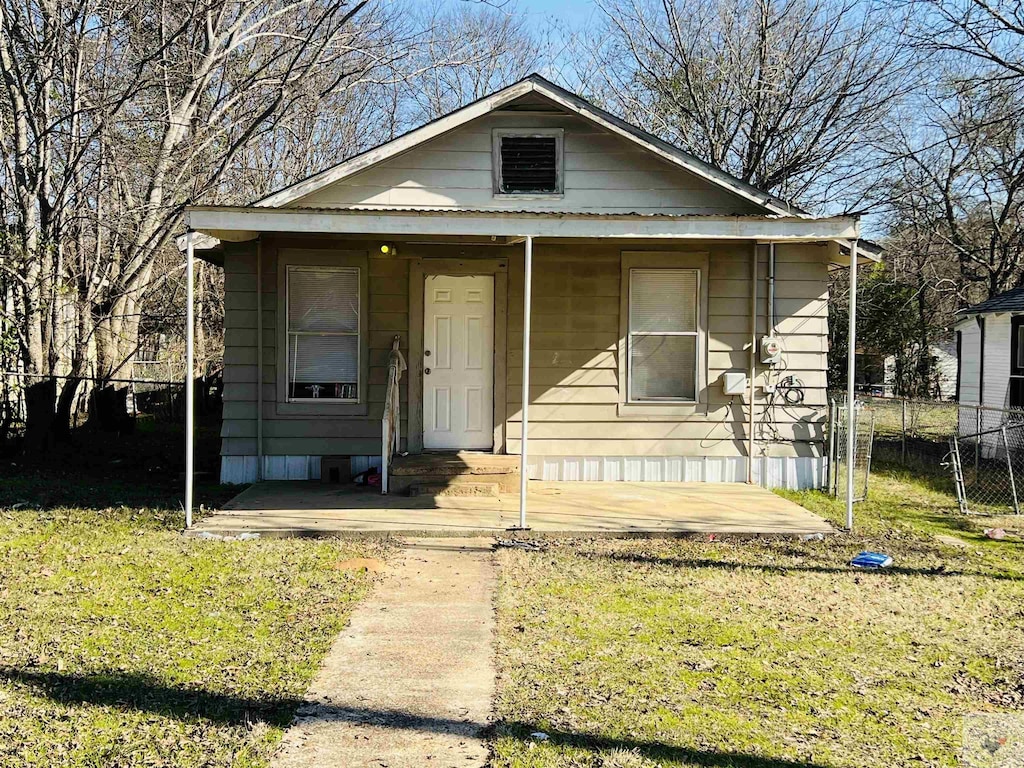 bungalow-style home featuring a front yard