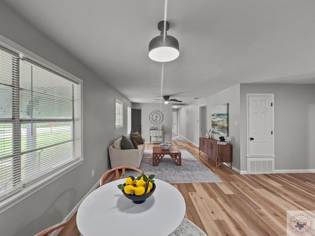 dining space featuring ceiling fan and light hardwood / wood-style floors