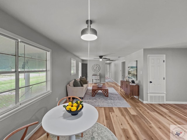 dining space featuring ceiling fan and light hardwood / wood-style flooring