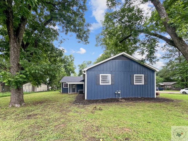 view of side of property with a yard