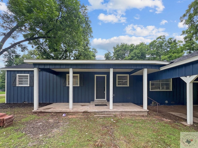 rear view of property featuring a porch