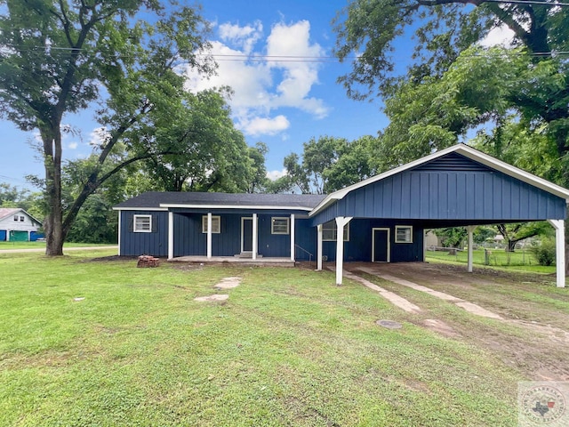 single story home featuring covered porch, a front lawn, and a carport