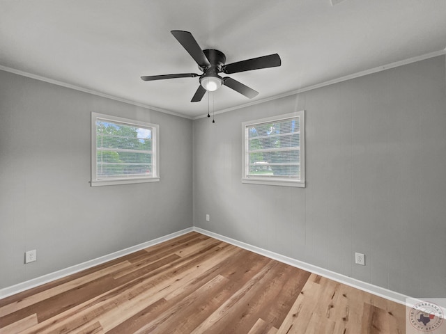 empty room with ceiling fan, light hardwood / wood-style flooring, a wealth of natural light, and ornamental molding