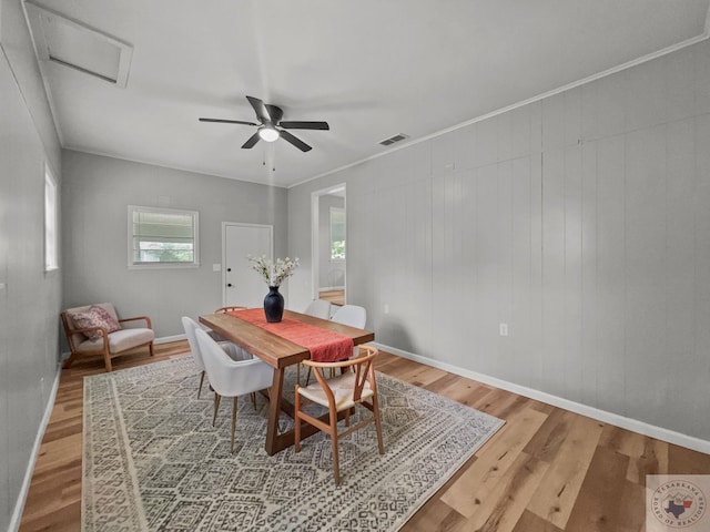 dining room featuring hardwood / wood-style flooring, ceiling fan, and crown molding