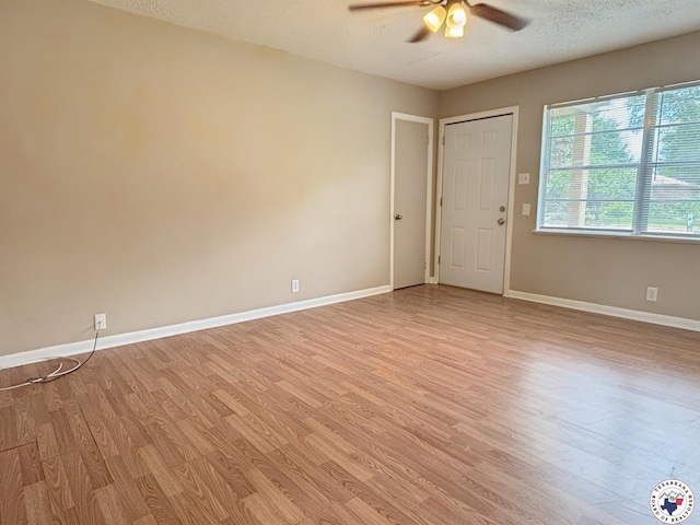 3703 Hickory St, Texarkana, AR 71854 - empty room featuring a ceiling fan, light wood-style flooring, and a textured ceiling