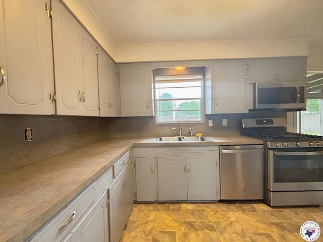 3703 Hickory St, Texarkana, AR 71854 - kitchen with stainless steel appliances, ornamental molding, decorative backsplash, and gray cabinetry