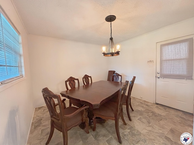3703 Hickory St, Texarkana, AR 71854 - dining area with a chandelier, a textured ceiling, crown molding, and stone finish flooring