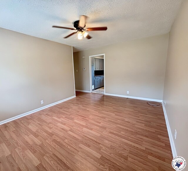 3703 Hickory St, Texarkana, AR 71854 - unfurnished room with a ceiling fan, light wood finished floors, and a textured ceiling