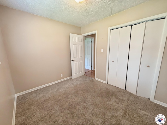3703 Hickory St, Texarkana, AR 71854 - unfurnished bedroom featuring carpet floors, a closet, and a textured ceiling