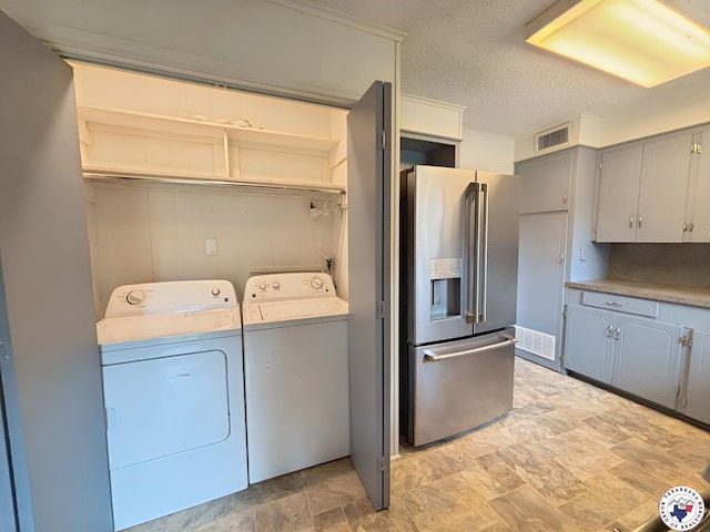 3703 Hickory St, Texarkana, AR 71854 - washroom featuring washer and dryer, stone finish flooring, and a textured ceiling