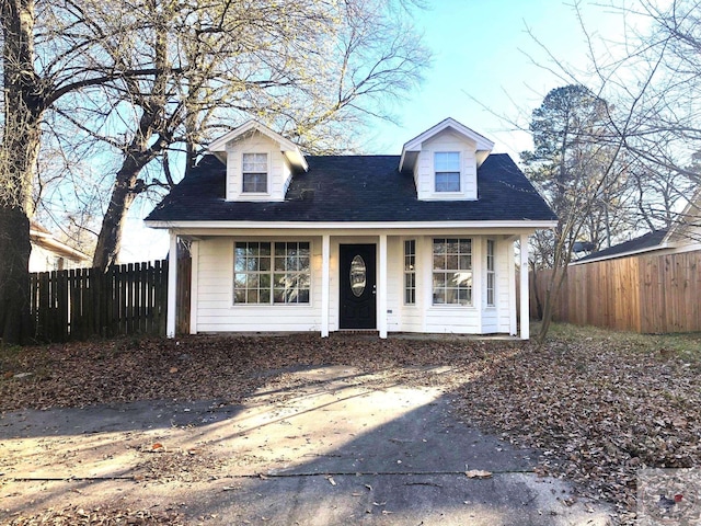 cape cod-style house with covered porch