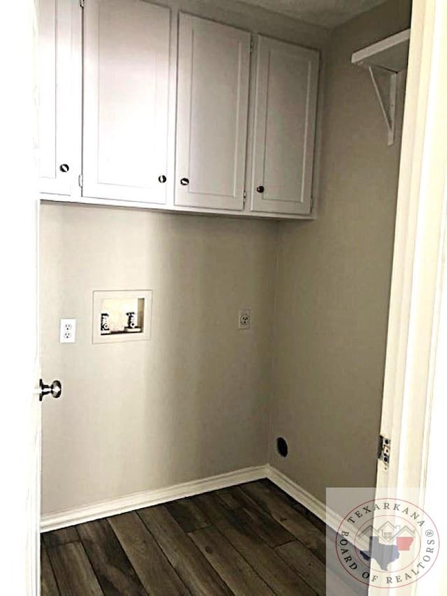 washroom featuring hookup for a washing machine, cabinet space, dark wood-type flooring, hookup for an electric dryer, and baseboards