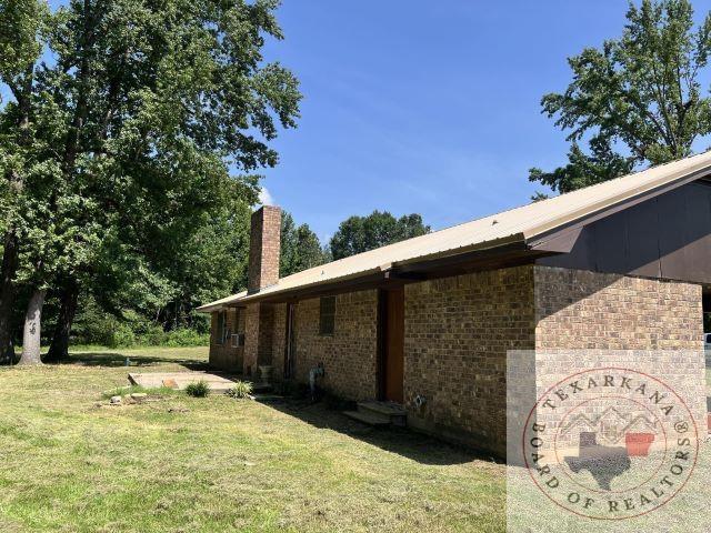 view of side of home with a lawn