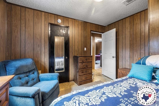 203 Pleasant Vly, Texarkana, AR 71854 - bedroom featuring wooden walls, a textured ceiling, and light carpet