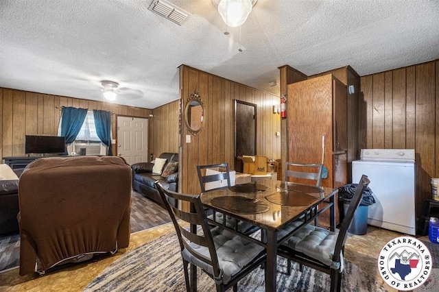 203 Pleasant Vly, Texarkana, AR 71854 - dining space with washer / dryer, wooden walls, ceiling fan, and a textured ceiling